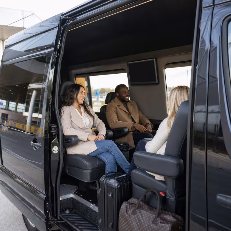 Passengers loading luggage while boarding an Sterling Heights group shuttle