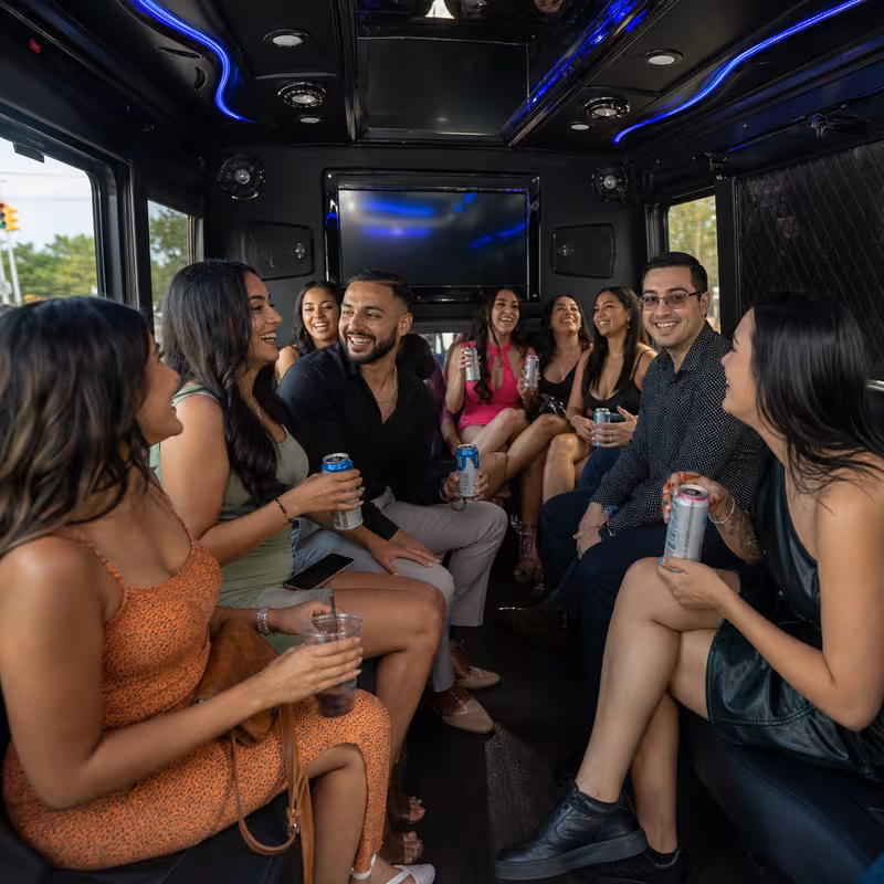 Party bus interior with wraparound leather seating and LED lighting in Sterling Heights