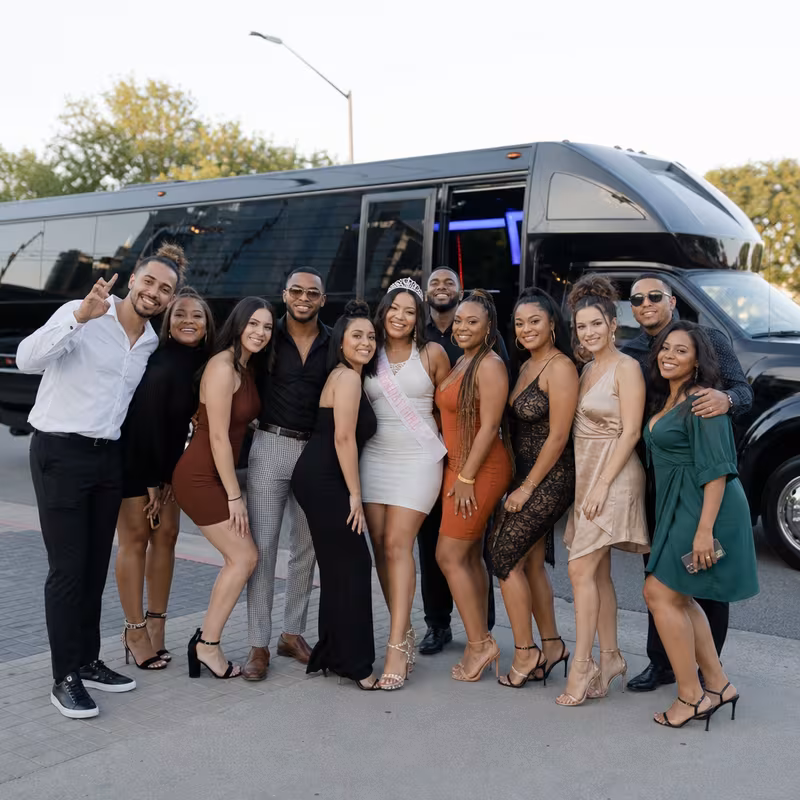 Group boarding a white charter bus for Birthday Transportation transportation in Sterling Heights