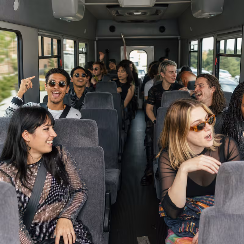 Party bus interior with wraparound leather seating and LED lighting in Sterling Heights