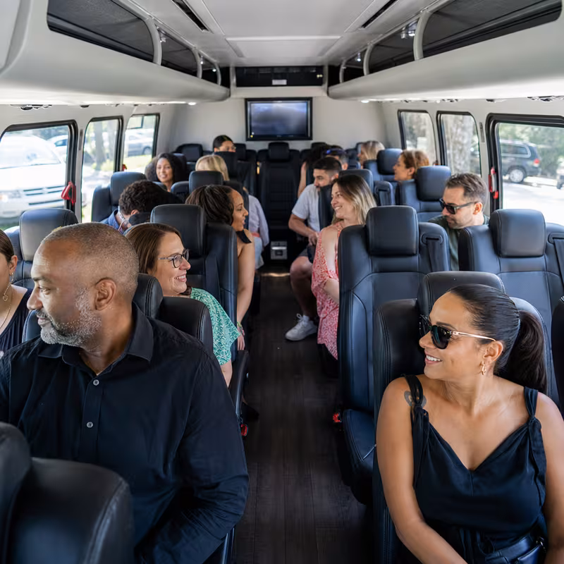 Group boarding a white charter bus for Private Event Transportation transportation in Sterling Heights