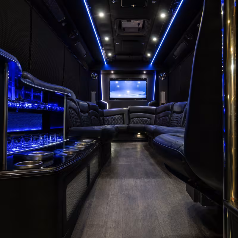 Party bus interior with wraparound leather seating and LED lighting in Sterling Heights