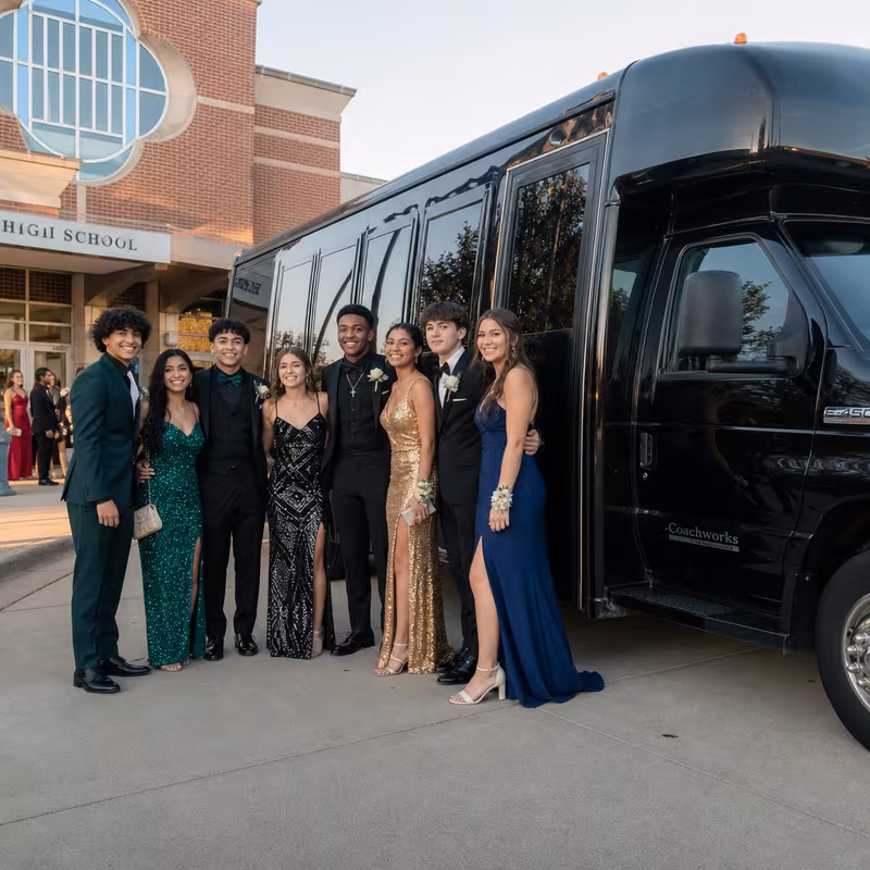 Group boarding a white charter bus for Prom & Homecoming Transportation transportation in Sterling Heights
