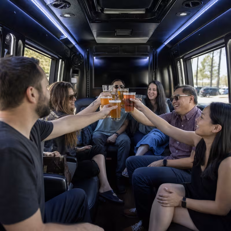 Group boarding a white charter bus for Winery & Brewery Tour Transportation transportation in Sterling Heights