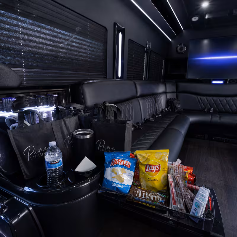 Party bus interior with wraparound leather seating and LED lighting in Sterling Heights